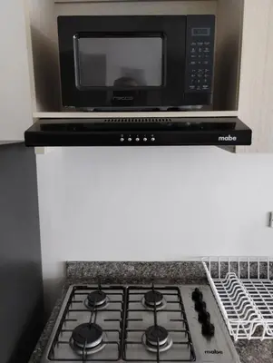 a microwave oven above a stove top oven at New Apartment Frente al Mar, Cerca Getsemani in Cartagena de Indias