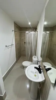 a bathroom with two sinks and a toilet and a shower at Lindo & Cómodo Apartamento en La boquilla in Cartagena de Indias