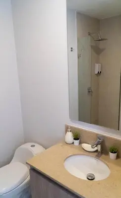 a bathroom with a sink and a toilet and a mirror at Loft Privado , Sunset y armonia in Santa Marta