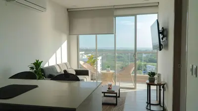 a living room with a view of a living room at Loft Privado , Sunset y armonia in Santa Marta