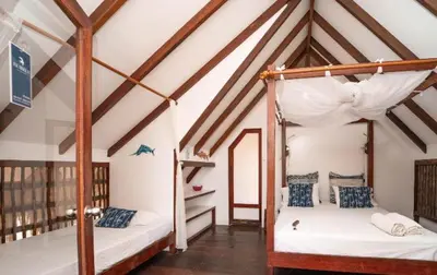 a bedroom with two bunk beds in a attic at Eco Hotel Islabela Deluxe in Isla Grande