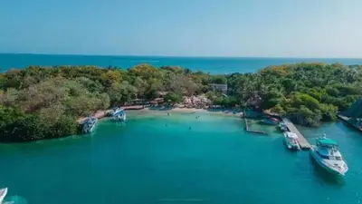 a group of boats docked at a dock in the water at Eco Hotel Islabela Deluxe in Isla Grande