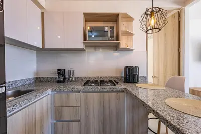 a kitchen with a counter with a sink and a stove at MarNilo House Serena del Mar Cartagena in Cartagena de Indias