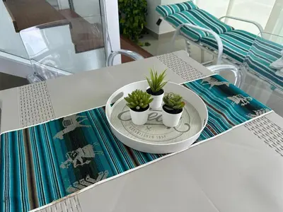 a table with three potted plants on a plate at Espectacular apartamento vista al centro y al Mar in Cartagena de Indias