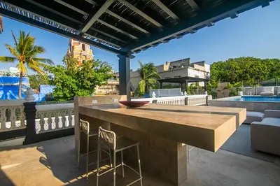 a patio with a table and chairs on a balcony at Casa De La Imprenta in Cartagena de Indias