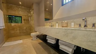a large bathroom with two sinks and a toilet at Casa De La Imprenta in Cartagena de Indias