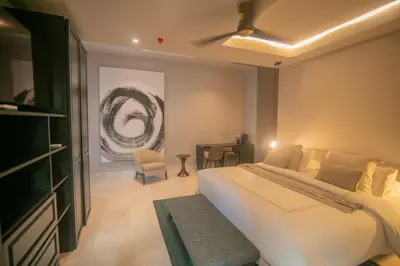 a bedroom with a large white bed and a desk at Casa De La Imprenta in Cartagena de Indias