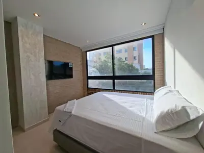a bedroom with a large bed and a large window at Edificio Shanty- Easy Rents Sas in Barranquilla