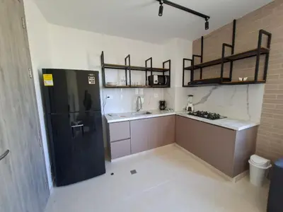 a kitchen with a black refrigerator and a sink at Edificio Shanty- Easy Rents Sas in Barranquilla