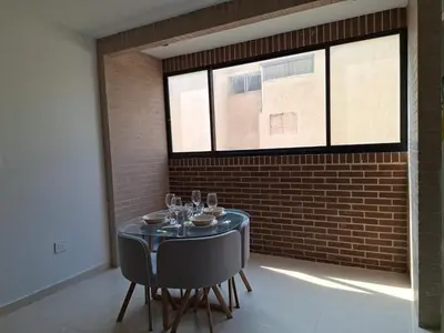 a dining room with a table and chairs and a brick wall at Edificio Shanty- Easy Rents Sas in Barranquilla
