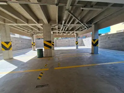 an empty parking lot with yellow and black lines on the ground at Edificio Shanty- Easy Rents Sas in Barranquilla