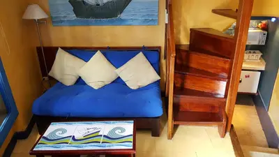a bedroom with a blue bed with pillows and a staircase at Apto exclusivo Centro Historico in Cartagena de Indias