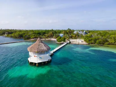 an island with a boat in the water at Quinta del Mar Tintipán in Isla Mucura