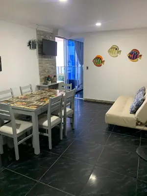 a dining room with a table and chairs and a couch at Apartamento Boutique Cartagena in Cartagena de Indias