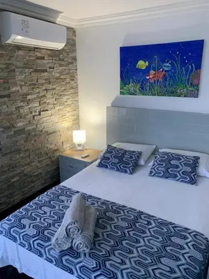 a bedroom with a bed and a painting on the wall at Apartamento Boutique Cartagena in Cartagena de Indias