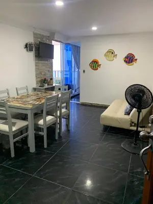 a living room with a table and chairs and a kitchen at Apartamento Boutique Cartagena in Cartagena de Indias