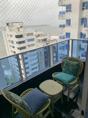 a balcony with two chairs and a table and some buildings at Apartamento Boutique Cartagena in Cartagena de Indias
