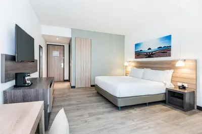 a hotel room with a bed and a flat screen tv at Holiday Inn Express - Barranquilla Buenavista by IHG in Barranquilla
