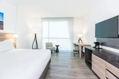 a hotel room with a bed and a tv and a desk at Holiday Inn Express - Barranquilla Buenavista by IHG in Barranquilla