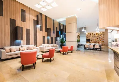 a lobby with couches and chairs and a bar at Holiday Inn Express - Barranquilla Buenavista by IHG in Barranquilla