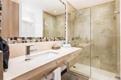 a bathroom with a sink and a shower at Holiday Inn Express - Barranquilla Buenavista by IHG in Barranquilla