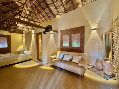 a living room with a couch and a bed at Awa de Mar Playa in Tolú