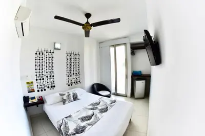 a bedroom with a bed and a ceiling fan at Hotel Florida Sincelejo in Sincelejo