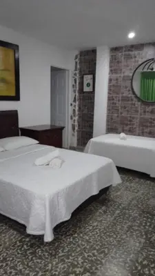 a hotel room with two beds and a tub at Hotel Fegali Art Boutique in Cartagena de Indias