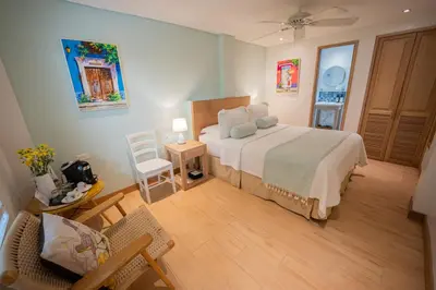 a bedroom with a bed and a table and chairs at Posada La Fe in Cartagena de Indias