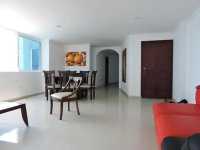 a living room with a table and chairs at Apartamento Laguito Bocagrande in Cartagena de Indias