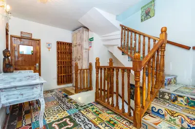 a room with a staircase and a desk at Voilá Signature Casa Isabel in Cartagena de Indias