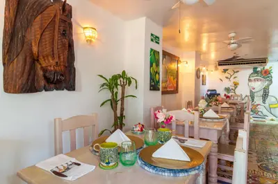 a dining room with a table and a dining room at Voilá Signature Casa Isabel in Cartagena de Indias