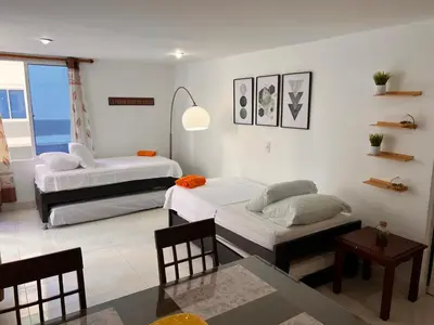 a living room with two beds and a table at Apartamento Nuevo Conquistador in Cartagena de Indias