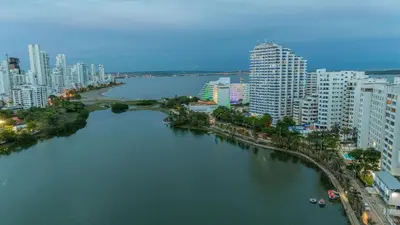 a river in the middle of a city with tall buildings at Poseidon Lake Apartments in Cartagena de Indias