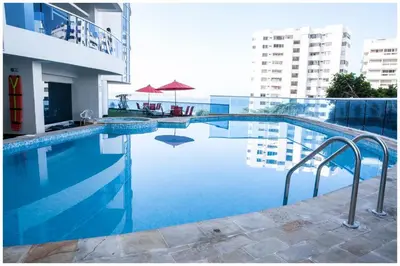 a swimming pool with blue water in a building at Poseidon Lake Apartments in Cartagena de Indias