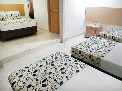 two beds in a room with two beds sidx sidx sidx at Hotel Plaza 43 in Barranquilla