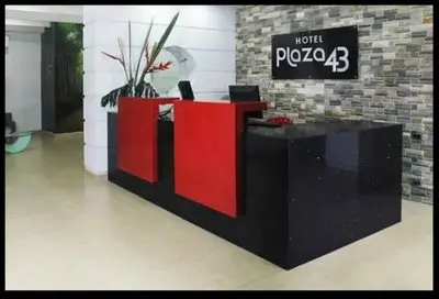 a lobby with a red and black desk in a room at Hotel Plaza 43 in Barranquilla