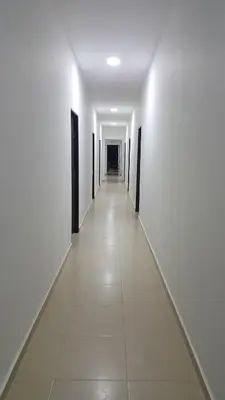 an empty corridor with white walls and a long white hallway at Hotel Sofichic Barranquilla in Barranquilla