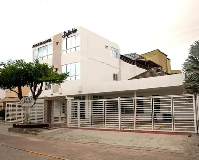 a white building with a sign in front of it at Hotel Sofichic Barranquilla in Barranquilla