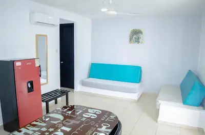 a room with a bed and a couch and a bench at Hotel Sofichic Barranquilla in Barranquilla