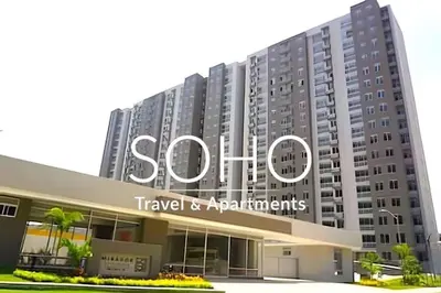 a large building with a sign that reads shuttle travel and apartments at Apartamentos Mirador - Excelente Ubicación by SOHO in Barranquilla