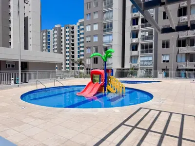 a small pool with a playground in a city at Apartamentos Mirador - Excelente Ubicación by SOHO in Barranquilla