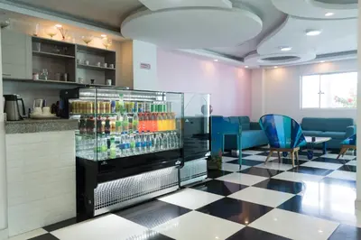 a drink refrigerator in a restaurant with blue chairs at Hotel Aquarius in Barranquilla