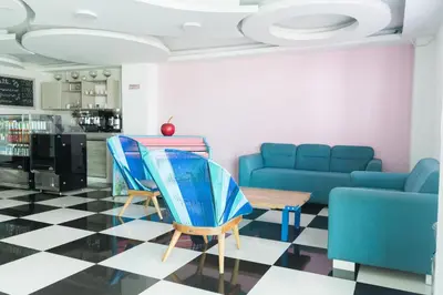 a living room with a couch and chairs and a table at Hotel Aquarius in Barranquilla