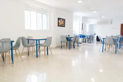a dining room with blue tables and chairs at Hotel Aquarius in Barranquilla