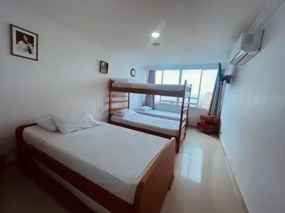 a bedroom with two bunk beds and a window at Cartagena El Laguito Apto cerca a la playa in Cartagena de Indias