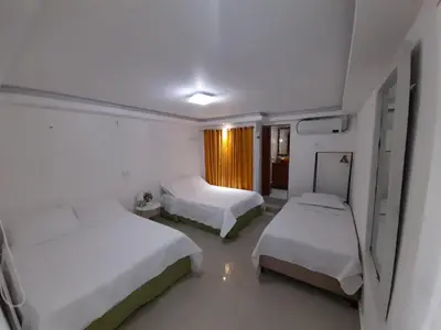 a hospital room with two beds and a window at Hostal Casa de las Americas in Cartagena de Indias