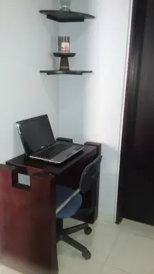 a laptop computer sitting on a desk with a chair at Cartagena - Torremarina in Cartagena de Indias
