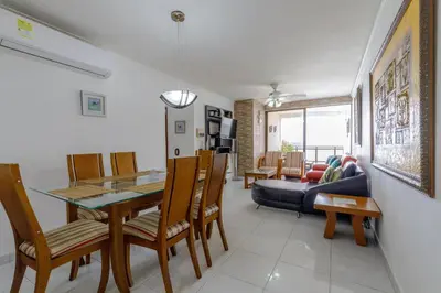 a dining room and living room with a table and chairs at Cartagena - Torremarina in Cartagena de Indias