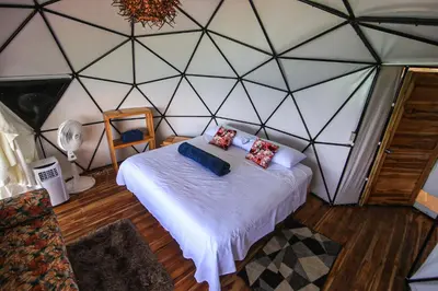 a room with a bed in a triangular wall at La Cabaña Glamping Geronimo in Playa Blanca